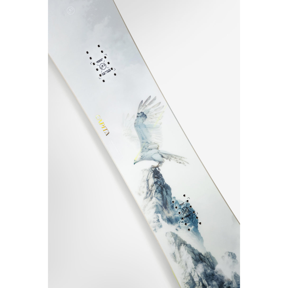 Snowboard with artistic design of an eagle and mountain on a white background