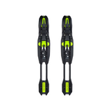 Pair of black ski bindings with green accents on a white background